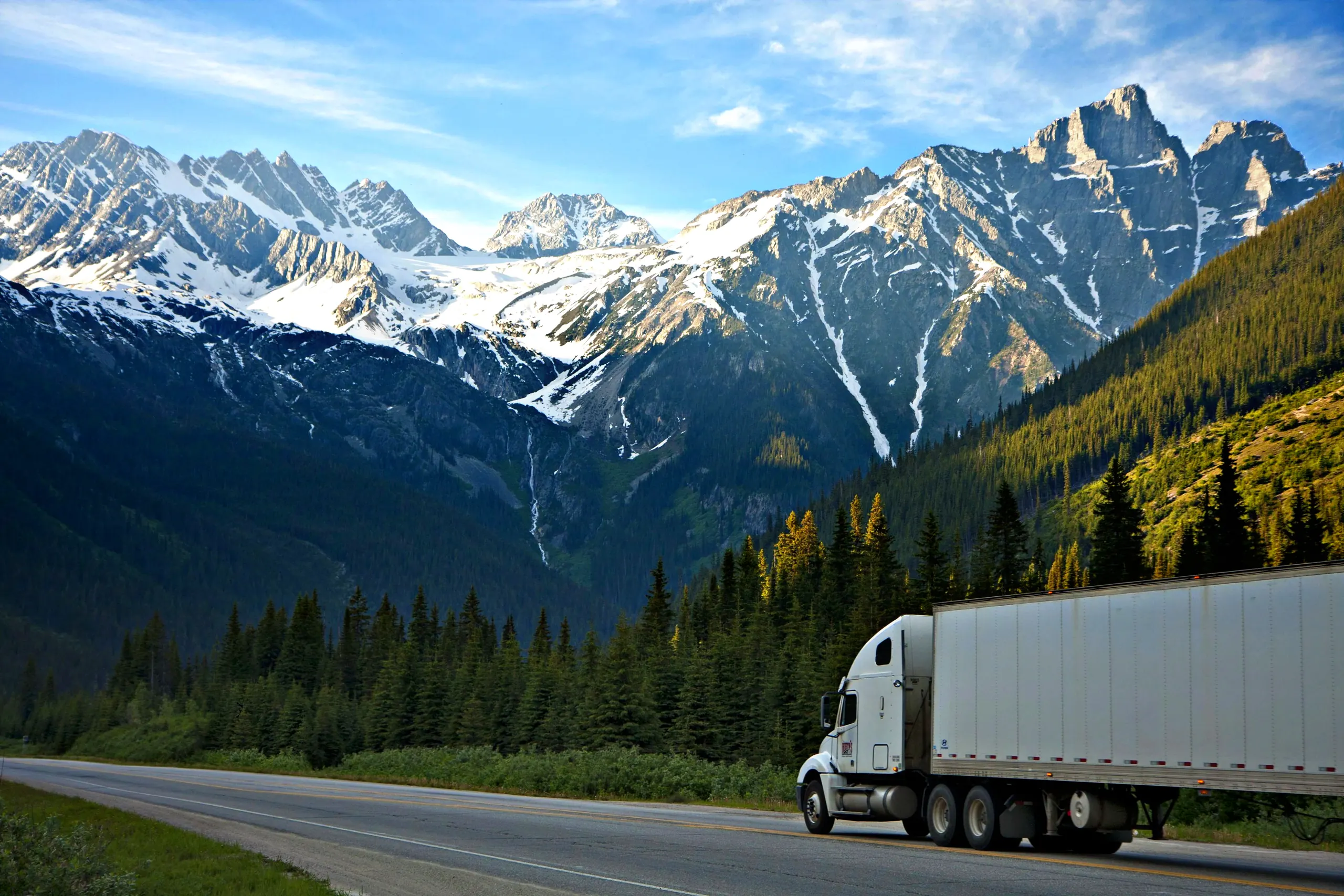 White semi truck on a scenic mountain highway